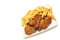 Golden brown fried chicken served with fries