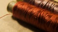 Golden-brown and purple sewing thread Royalty Free Stock Photo