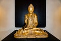 Golden Buddha, black background,