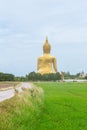 Large Buddha statue at Wat Muang in Angthong in back side rural landscape in Thailand.