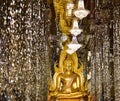 A golden Buddha and crystal pillars at Wat Tha Sung temple