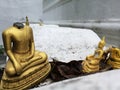 Golden Buddha figurines with missing head, detail and closeup of gold Buddha statues