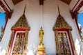 Golden Buddha is in fornt of the doors of the temple Royalty Free Stock Photo