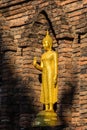 Golden Buddha in front of ancient Maha Chedi in North of Thailand