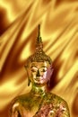 Golden Buddha in gold background, buddhist religion