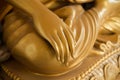 Golden Buddha hand on knee of statue Royalty Free Stock Photo