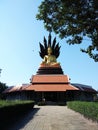 Golden Buddha sitting position sheltered by Naga hood Royalty Free Stock Photo