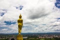 Golden Buddha standing with cloud and sky and Nan city background Royalty Free Stock Photo