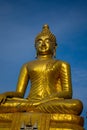 Golden Buddha statue against a blue sky. Royalty Free Stock Photo