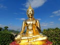 Golden Buddha statue against blue sky and clouds in Thailand temple, Wat Phra That Phasornkaew Khao Kho District, Phetchabun Royalty Free Stock Photo