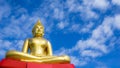 Golden Buddha statue against blue sky in Thailand temple Royalty Free Stock Photo