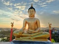 Golden Buddha statue against sunset sky in Thailand temple Royalty Free Stock Photo