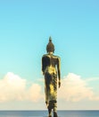 Golden Buddha Statue from Back with Blue Sky and Blue Sea, Evening Shot