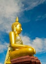 Golden Buddha statue against blue sky in a Buddhist temple Royalty Free Stock Photo