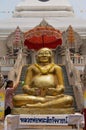 Golden Buddha statue in front of the Wat Phra That Chedi in Nong Khai, Thailand.