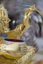 Golden Buddha statue, hand closeup with blurred background Royalty Free Stock Photo