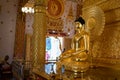 Golden Buddha statue inside the Wat Phrathat Nong Bua temple in Ubon Ratchathani, Thailand