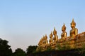 The golden Buddha statue of Phu Salao temple in beautiful sunset moment at Pakse