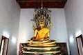 The golden Buddha statue sheltered by naga hood in a Thai temple Royalty Free Stock Photo