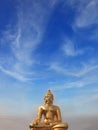 Golden Buddha statue shining in the sun Royalty Free Stock Photo