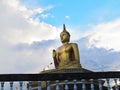 Golden buddha statue with a spectacular of clouds and sky backgr Royalty Free Stock Photo