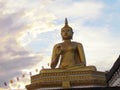 Golden buddha statue with a spectacular of clouds and sky backgr Royalty Free Stock Photo