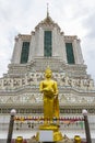 Golden buddha statue standing in front of the ancient pagoda at Royalty Free Stock Photo