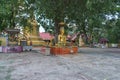 Golden buddha statue and stupa in a temple in Chiang Rai