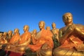 golden buddha statue in temple with beautiful morning light against blue sky use for multipurpose in religion theme