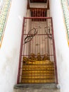 Golden Buddha statues behind bars in the Wat Arun Temple in Bangkok, Thailand Royalty Free Stock Photo