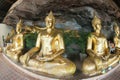 Golden Buddha statues in a cave at Buddhist temple.