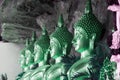 Golden Buddha statues in a cave at Buddhist temple.