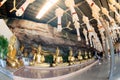 Golden Buddha statues in a cave at Buddhist temple.