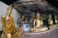 Golden Buddha statues in a cave at Buddhist temple.