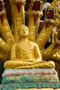 Golden Buddha statues sitting with Naka snake in Thai Temple Royalty Free Stock Photo