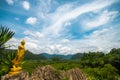 Golden Buddha at the viewpoint in Phatthalung Province with background of sky and clouds, mountain, Thailand. Royalty Free Stock Photo