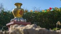 buddhist figure outside with plants