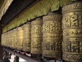 Golden buddhist prayer wheels with the inscription \