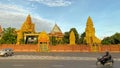 Golden buildings Buddhist wat motorcycle Cambodia