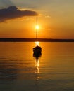 sunset at lake Ammersee in Herrsching with a sailing boat resting on the water on a warm August night (Bavaria, Germany) Royalty Free Stock Photo