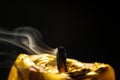 Golden candle macro dust after breath black background Royalty Free Stock Photo