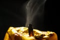Golden candle macro dust after breath black background Royalty Free Stock Photo