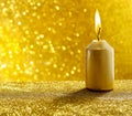 Golden candles. Gold glittering christmas lights. Blurred abstract background