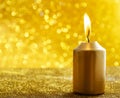 Golden candles. Gold glittering christmas lights. Blurred abstract background