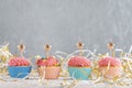 Golden candles in the shape of star on cupcakes. Muffins with pink buttercream frosting on festive tinsel background. Copy spacve Royalty Free Stock Photo