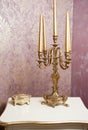 Golden candlestick with five candles on white table