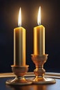 Golden candlesticks with burning candles on a soft dark background