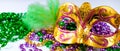Golden carnival mask and colorful beads close-up. Mardi Gras or Fat Tuesday symbol. Royalty Free Stock Photo