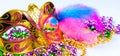 Golden carnival mask and colorful beads on white background. Closeup symbol of Mardi Gras or Fat Tuesday.