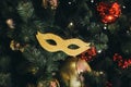 Golden carnival mask like a Christmas tree toy Royalty Free Stock Photo